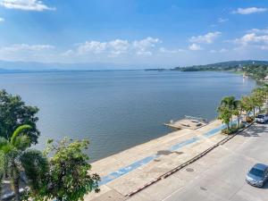 a view of a large body of water with palm trees at ฤกษ์ดี RerkDee bed and Breakfast in Phayao