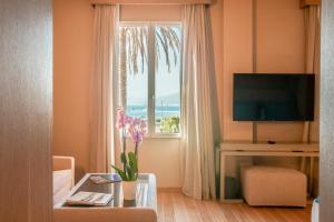 a living room with a window with a view of the ocean at Miramare Suites in Sestri Levante