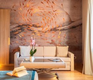 a living room with a couch and a painting on the wall at Miramare Suites in Sestri Levante