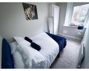 a bedroom with a bed with a pillow on it at Strudel House - Luxury 1 Bed Apartment in Aberdeen City Centre in Aberdeen