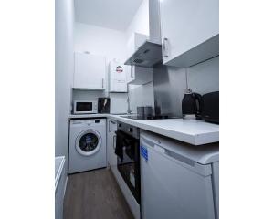 a kitchen with a washing machine and a dishwasher at Strudel House - Luxury 1 Bed Apartment in Aberdeen City Centre in Aberdeen