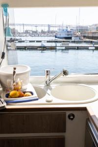 a bathroom counter with a sink and a view of the water at Minty of Kip in Lisbon