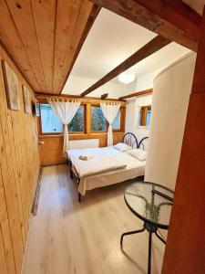 a bedroom with a bed and a table in a room at Dream House Brasov in Braşov