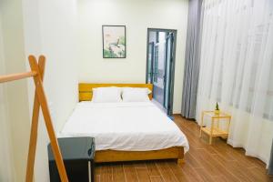 a bedroom with a bed and a tv in it at TUY HOA CASA in Liên Trì (3)