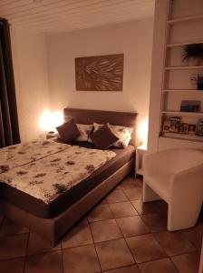 a bedroom with a bed with two pillows on it at Gäste Apartement Casa Luber in Thalmassing