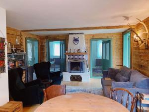 a living room with a couch and a fireplace at Comandau 11 in Comandău