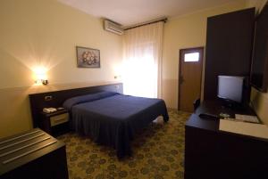 Postel nebo postele na pokoji v ubytování Hotel Riviera