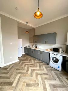 a large kitchen with a washer and dryer in it at Stevenson Apartment in Alexandria