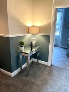 a room with a desk with a lamp on it at Stevenson Apartment in Alexandria