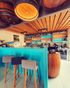 a restaurant with a blue bar with stools at Sousedi Pavlov in Pavlov