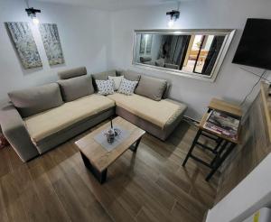 a living room with a couch and a table at Kuća za odmor Potjeh in Slavonski Brod