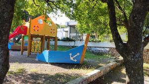 a playground with a slide in a park at MOBILE HOME Klenovica SONČEK in Klenovica
