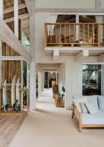 a living room with a couch and surfboards at Casa Arena Beachfront Property in Santa Teresa Beach