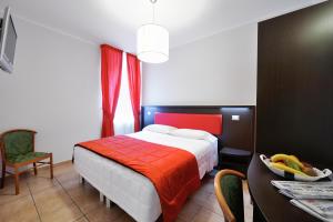 Säng eller sängar i ett rum på Hotel al Corso
