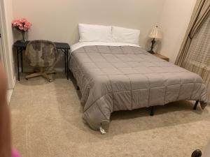 a bedroom with a bed and a desk with a chair at High End Triplex with Pool in Riverside