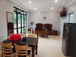 a kitchen and dining room with a table and chairs at Siem Reap home in Siem Reap