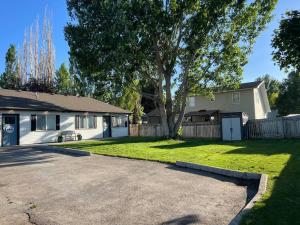 a house with a tree and a driveway at Heritage Suites 1998 #4- Peaceful 1 bedroom 1 bath Suite in Idaho Falls