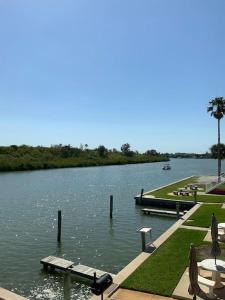 a view of a lake with a dock and benches at Piece of Paradise in Clearwater Beach