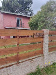 a wooden fence in front of a house at Nalu in La Paloma