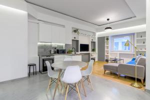 a kitchen and living room with a table and chairs at Kolonaki Suite in Athens in Athens