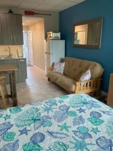 a room with a bed and a couch in a kitchen at Comfy Coastal Beach Vacation in Clearwater Beach