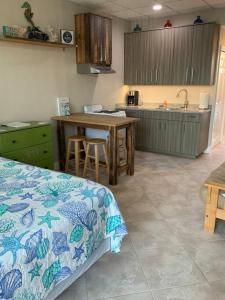 a kitchen with a bed and a table in a room at Comfy Coastal Beach Vacation in Clearwater Beach