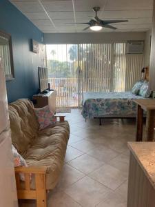 a living room with a couch and a bed at Comfy Coastal Beach Vacation in Clearwater Beach