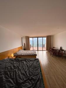 a bedroom with a bed and a dining room with a table at Homestay 1579 SaPa in Sapa +128 photos