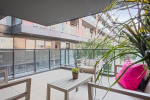a balcony with a table and chairs on a building at Aparthotel Bcn Montjuic in Barcelona