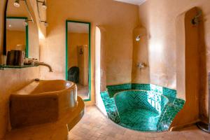 a large bathroom with a tub and a sink at Prestige du Souss in Oulad Berhil