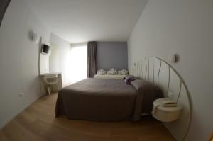 Postel nebo postele na pokoji v ubytování Aromi Piccolo Hotel