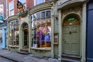 a store front with display windows on a street at 37a Stonegate Loft in York