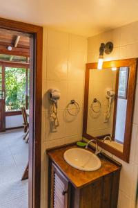 a bathroom with a sink and a mirror at Pousada Moradas da Silveira in Garopaba