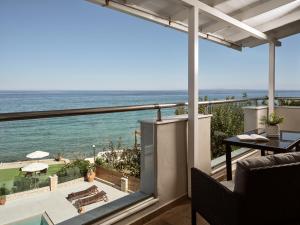 a view of the ocean from the balcony of a house at Stefania Apartments in Kipseli