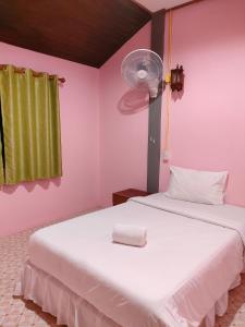 a bedroom with two beds and a fan at Garden View Resort Tonsai in Tonsai Beach