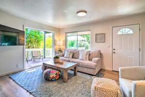 a living room with a couch and a table at Cozy Cali Condo, Walk to Summerland Beach! in Summerland