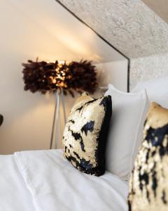 a black and white pillow sitting on a bed at Lodges Basel Euro Airport in Blotzheim