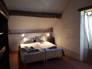 a bedroom with a bed in a room with a window at La Vache Tennis Privé in Crux-la-Ville