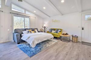 a bedroom with a large bed and a yellow chair at Game Room and Lake Access Serene Tobyhanna Retreat in Tobyhanna +31 photos