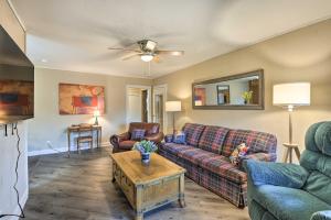 a living room with two couches and a table at Cozy Graham Retreat about 3 Mi to Lake Eddleman! in Graham