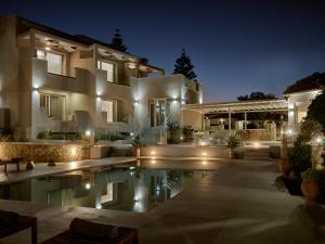 a house with a swimming pool at night at Stefania Apartments in Kipseli