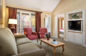 a living room with a couch and a tv at Club Wyndham Resort at Fairfield Glade in Fairfield Glade