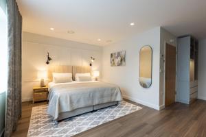 a bedroom with a large bed and a mirror at The Kingswood in St Austell +73 photos