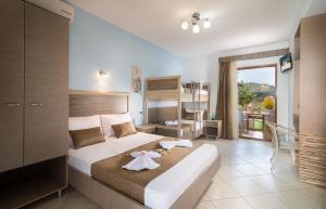 a bedroom with a bed with two towels on it at Rodon Garden in Sarti +45 photos