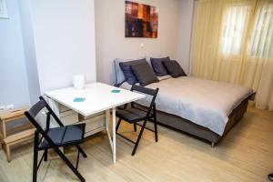 a bedroom with a bed and a table and chairs at Studio apartment with all amenities in Kolonaki in Athens +48 photos