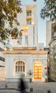 a white building with a yellow door in front at Rosetti Hotel in Bucharest