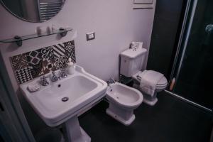 a bathroom with a sink and a toilet at Elephant's Smile B&B in Catania