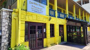 a yellow building with doors and a sign on it at Caribic House in Montego Bay