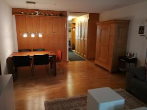 a living room with a wooden table and chairs at Rose Davos in Davos