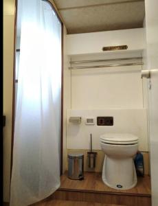 a bathroom with a toilet and a shower curtain at Minty of Kip in Lisbon